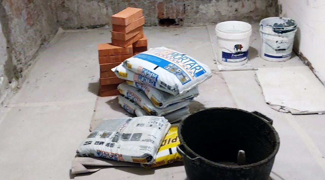 Materiali anti-umidità: sacchi di malta, mattoni e secchi. Essenziali per proteggere gli ambienti dall'umidità.